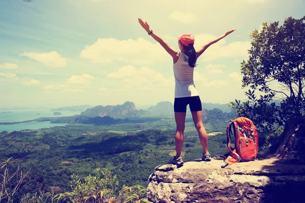 Cheering woman hiker