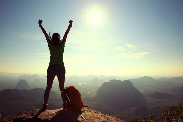 Cheering woman hiker