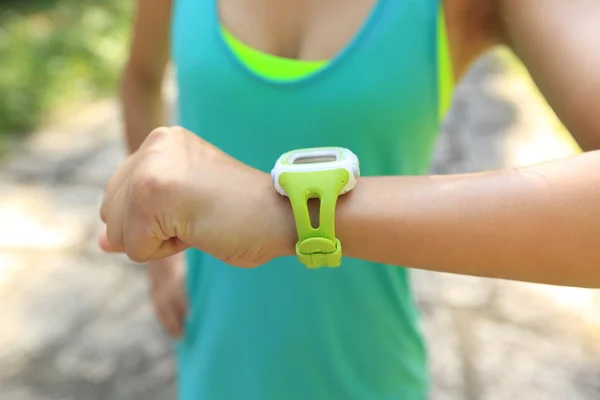 Woman jogger  looking  smart watch