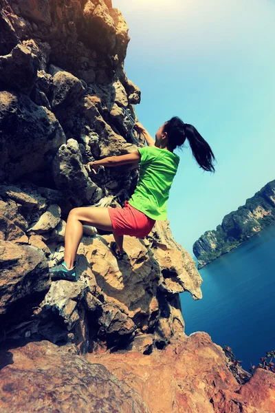 Woman climbing at seaside