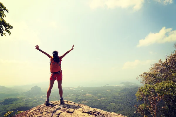 Cheering woman hiker open arms