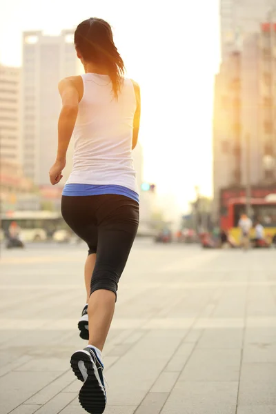 Runner athlete running on city street.