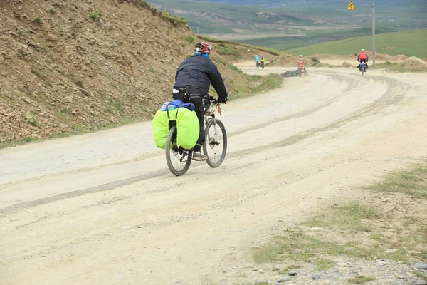 Mountain bike rides along the asphalt road