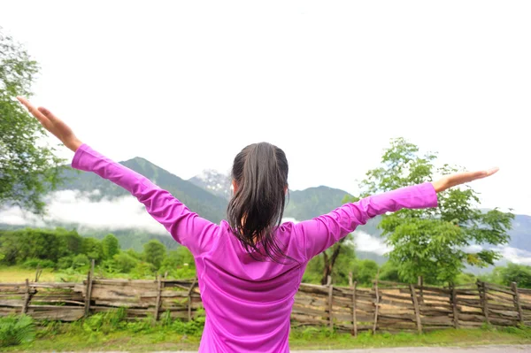 Cheering hiking woman enjoy the beautiful view at mountain peak