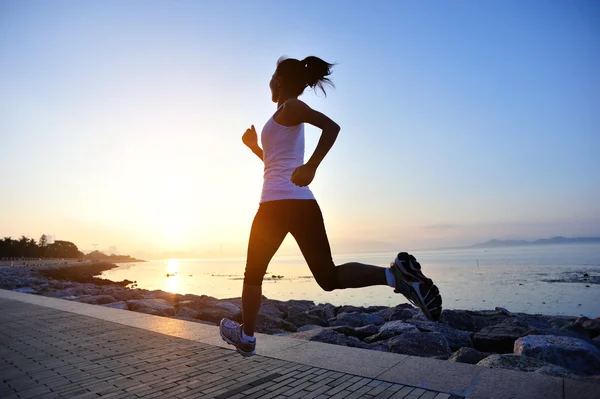 Runner athlete running at seaside. woman fitness silhouette sunrise jogging workout wellness concept.