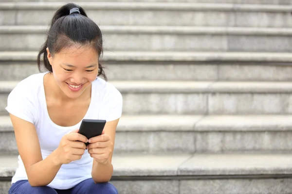 Beautiful young asian woman using smart phone