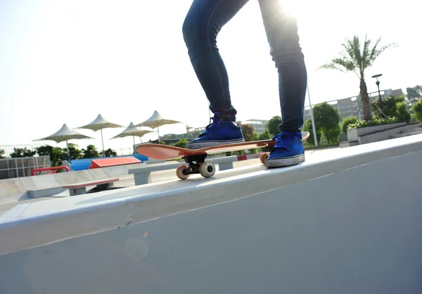 Skateboarding woman legs