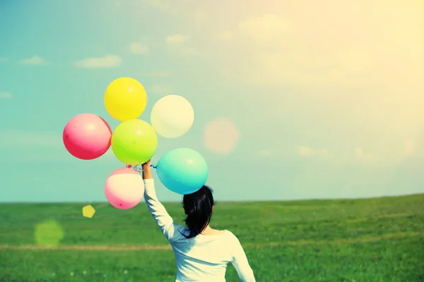 Woman with colored balloons