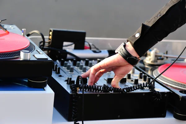 Male dj hand on soundboard