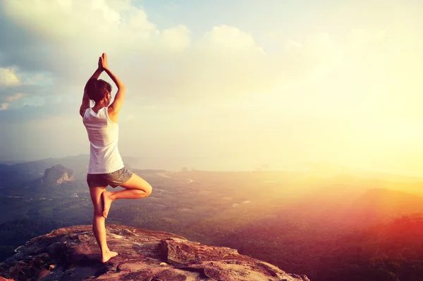 Woman meditating on mountain