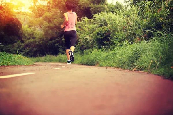 Young female running at forest