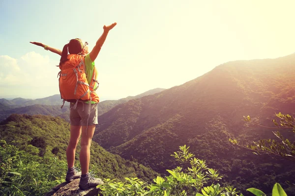 Cheering woman hiker with open arms