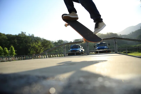 Skateboarder legs doing a trick ollie