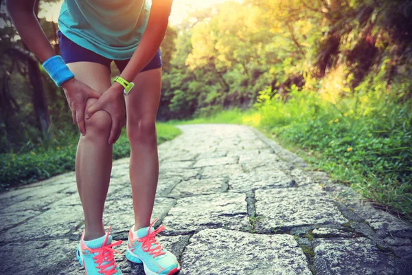 Woman runner hold  injured knee
