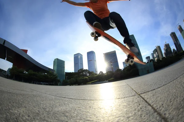 Skateboarder legs skateboarding at city