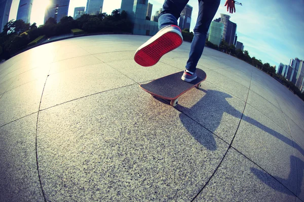 Female skateboarding at city