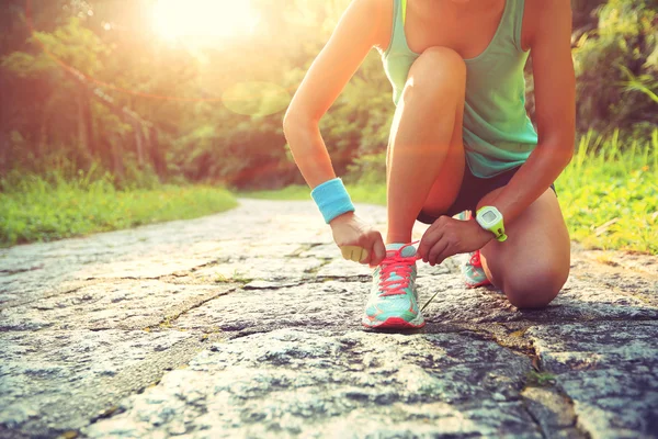 Woman runner tying shoelaces