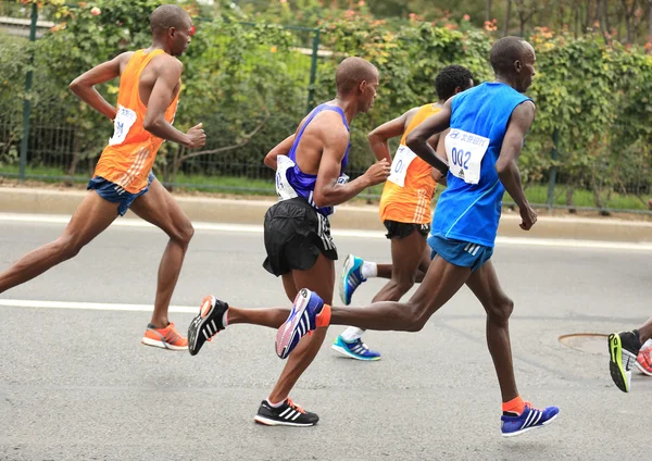 Marathon runners running on city road