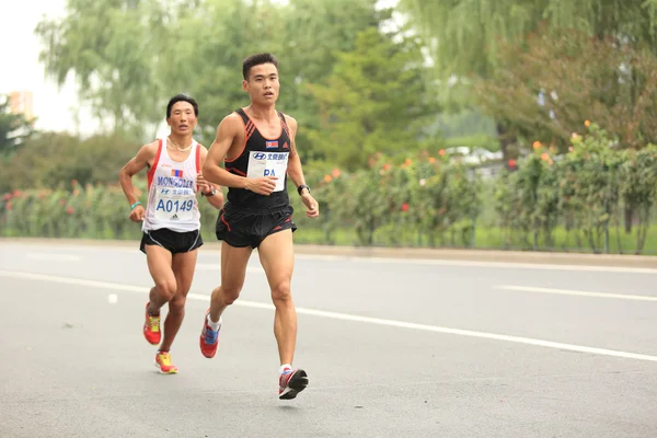 Marathon runners running on city road