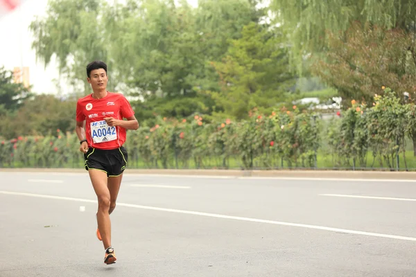 Marathon runner on city road