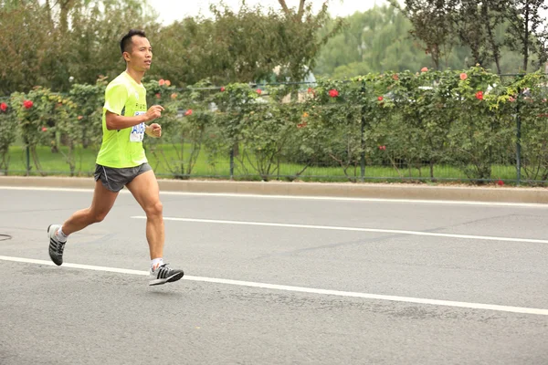 Marathon runner on city road