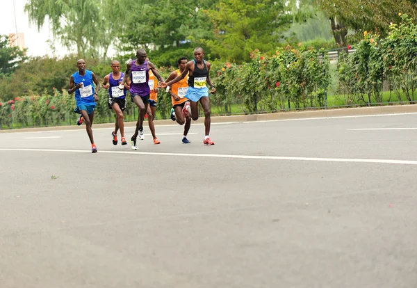 Marathon runners running on city road