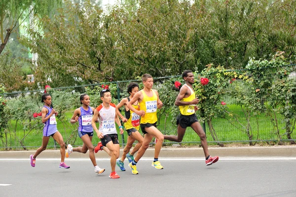 Marathon runners running on city road