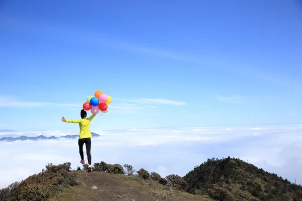 Cheering woman with colorful balloons