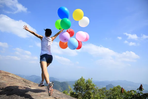 Cheering woman with colorful balloons