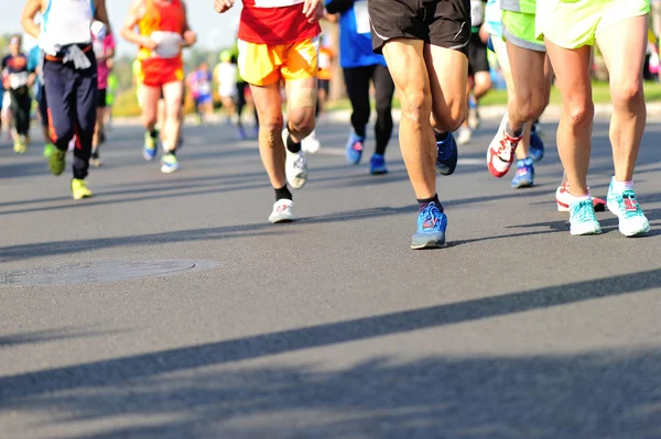 Marathon athletes running on road