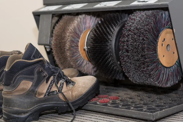 Walking shoes are in shoe polish machine