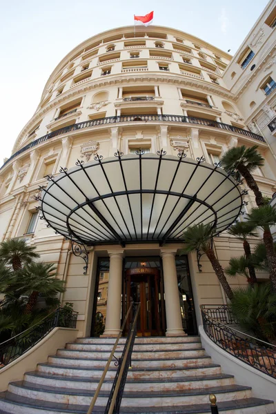 Monte-Carlo, Monaco, 25.09.2008: Hotel de Paris, bottom view, the famous canopy over the entrance to the hotel, at the top of the flag of Monaco