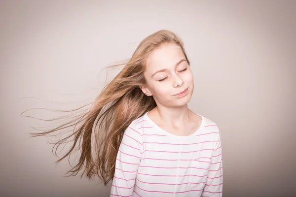 Child girl model with natural beautiful long straight hair.