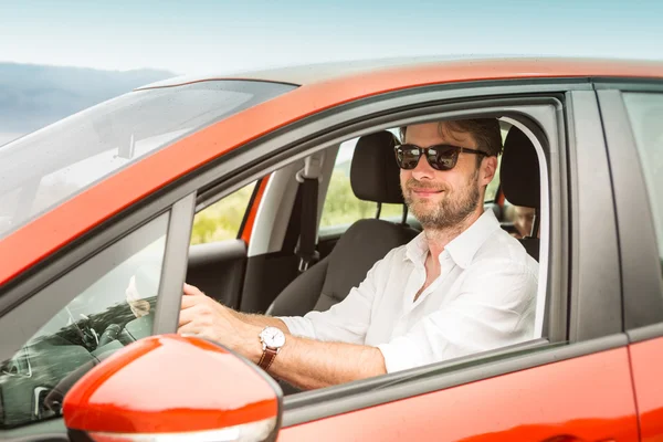 Forty years old caucasian man driving a car