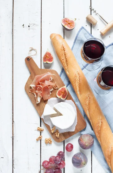 Camembert cheese, prosciutto, baguette and red wine