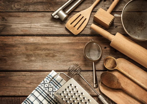 Rural kitchen utensils on vintage wood table from above