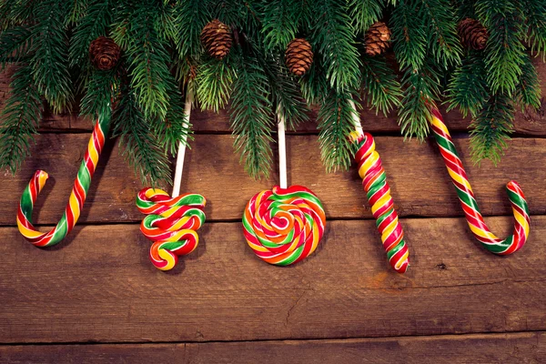 Merry Christmas. Christmas ornaments on wood with candy