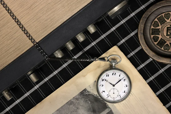 Old pocket watch on newspaper