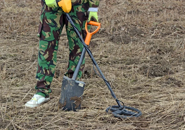 Treasure hunter. Man with metal detector