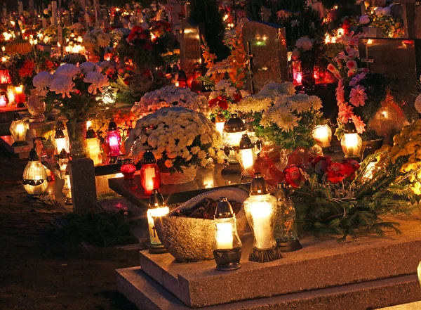 Candles Burning At a Cemetery During All Saints Day .