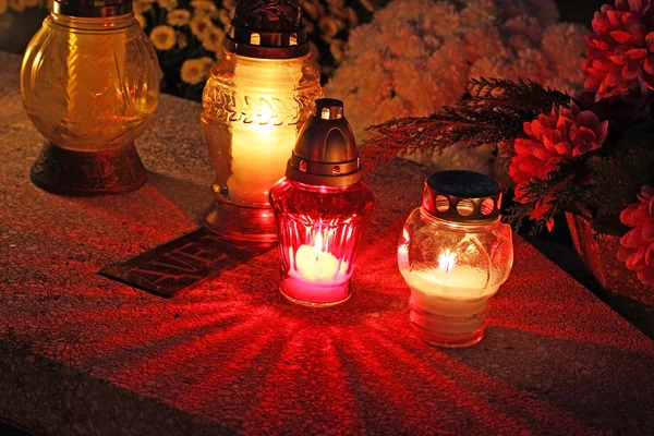 Candles Burning At a Cemetery During All Saints Day .