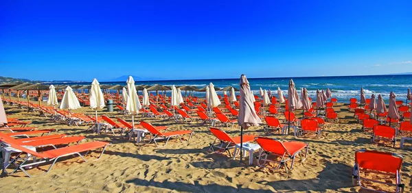 Umbrellas and sundecks of the sandy Banana Beach on Zakynthos, Greece. Banana is the largest beach of Zakynthos island.
