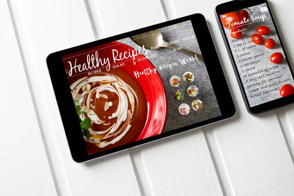 With tablet and smartphone healthy recipes blog on screen. Web o