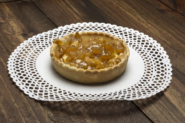 Apple pie and custard, on wood background
