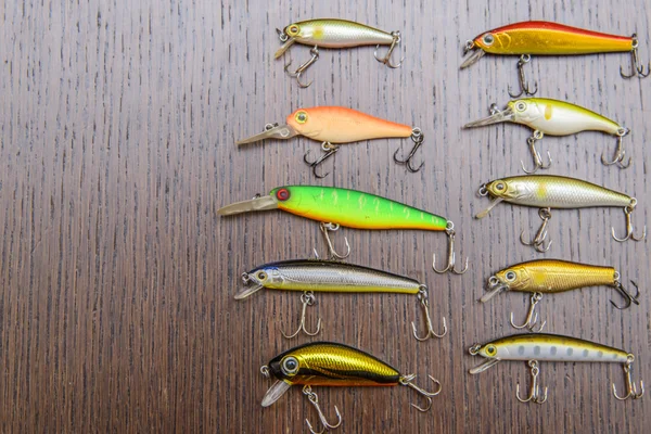 Fishing lures.fishing baits on a wooden brown table