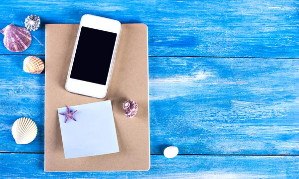 Shells, notebook and mobile phone,