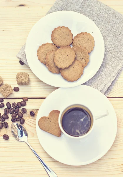 Ginger biscuits, cinnamon, a cup of hot coffee