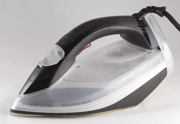 Steam iron on gray background