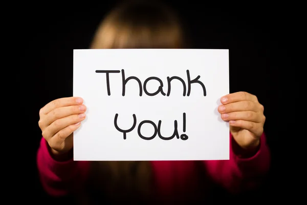 Child holding Thank You sign