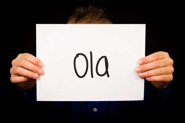 Child holding sign with Portuguese word Ola - Hello